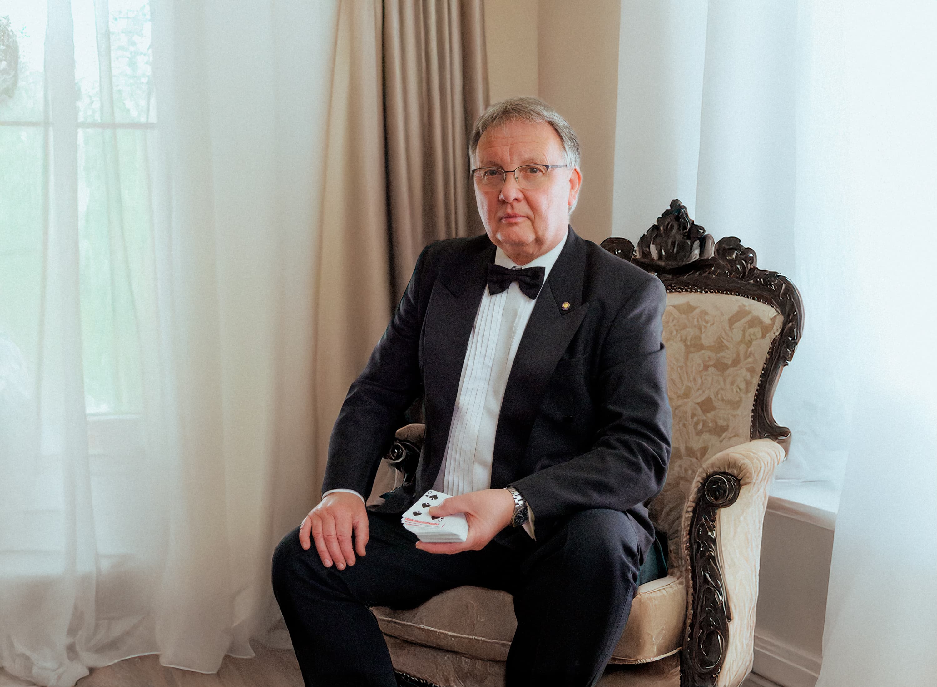 A magician sitting in a chair in a room in a country house