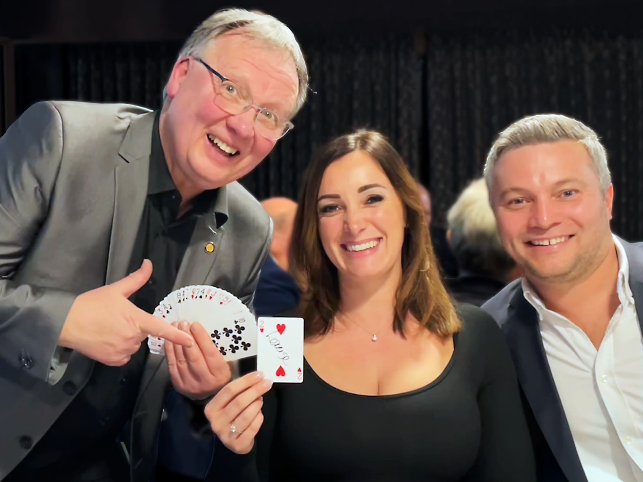 Brian with two people after a magic trick at a restaurant